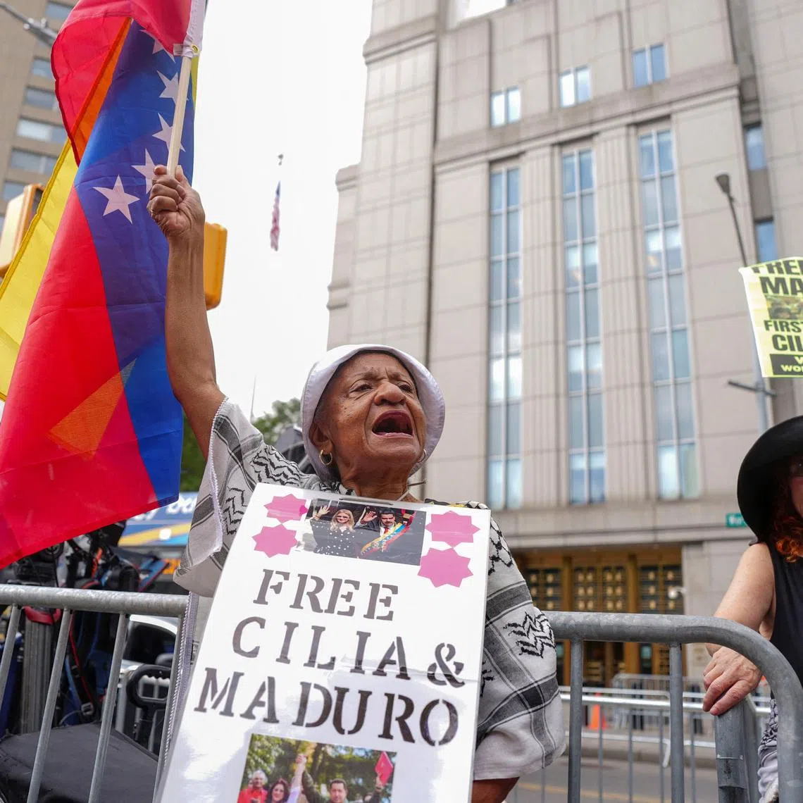 A person holds the Venezuelan flag on the day of the hearing on criminal charges, including narcoterrorism, against ousted Venezuelan president Nicolas Maduro and his wife Cilia Flores at the Daniel Patrick Moynihan United States Courthouse in New York City, U.S., July 22, 2026. REUTERS/Angelina Katsanis