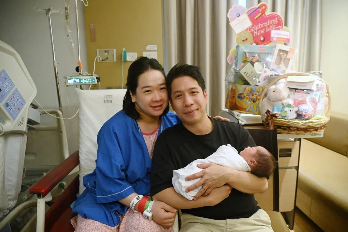 Madam Lam Nguyet Minh and her husband, Mr Noel Ng, with their son Denzel, who was born at 12.02am on Jan 1.