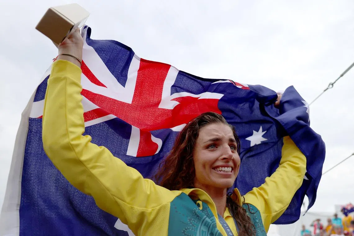 Paris 2024 Olympics - Slalom Canoe - Women's Canoe Single Victory Ceremony - Vaires-sur-Marne Nautical Stadium - Whitewater, Vaires-sur-Marne, France - July 31, 2024. Gold medallist Jessica Fox of Australia holds an Australian flag, as she celebrates after winning. REUTERS/Molly Darlington