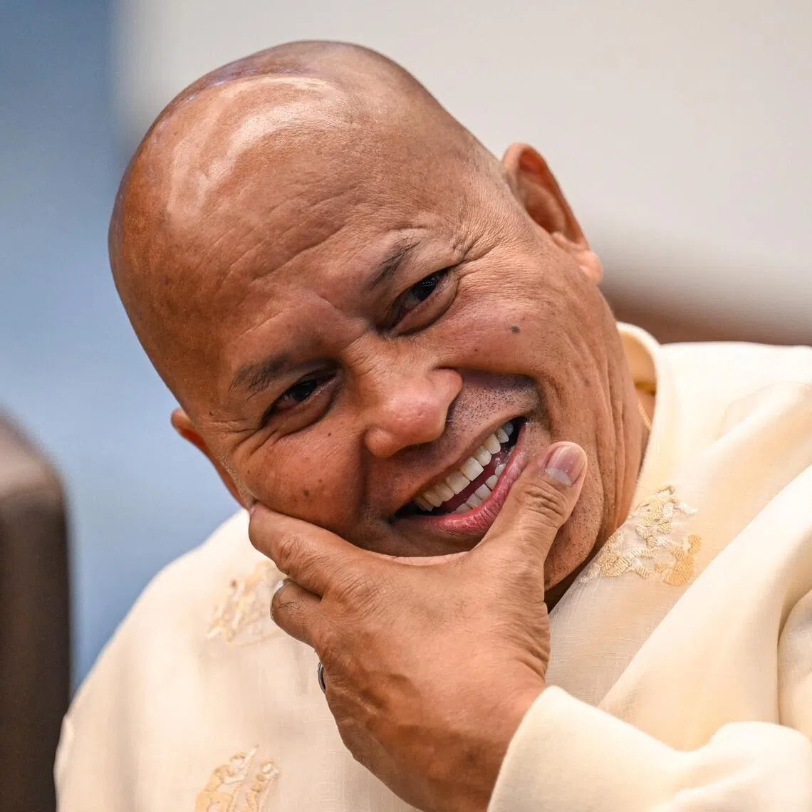 Philippine Senator Ronald Dela Rosa reacts as he talks to the media before the start of a plenary session at the Senate of the Philippines in Pasay, Metro Manila on May 12, 2026.
