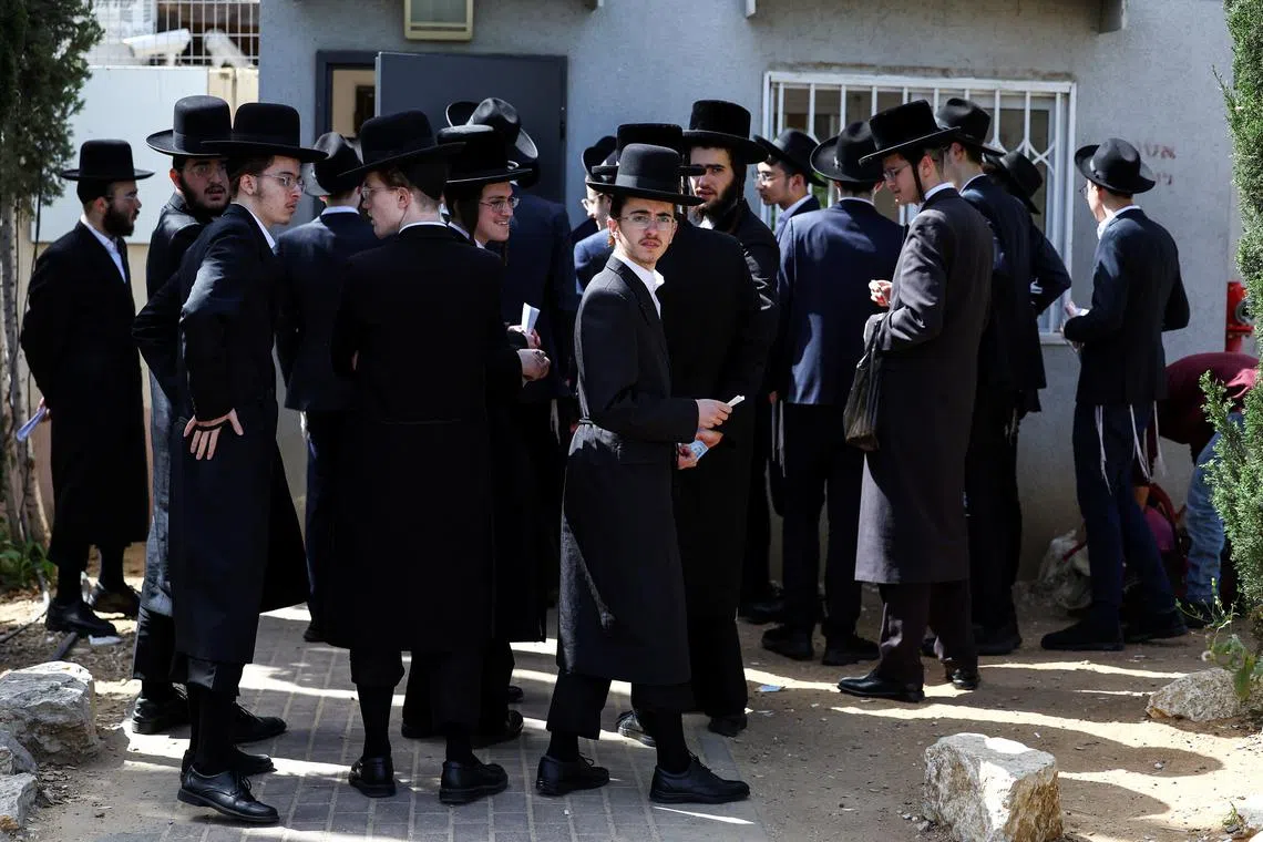 Ultra-Orthodox Jews line up at an Israeli draft office to process their exemptions from mandatory military service at a recruitment base in Kiryat Ono, Israel March 28, 2024. REUTERS/Hannah McKay