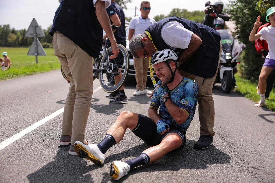 TOPSHOT - Astana Qazaqstan Team's British rider Mark Cavendish receives medical attention after suffering a crash during the 8th stage of the 110th edition of the Tour de France cycling race, 201 km between Libourne and Limoges, in central western France, on July 8, 2023. (Photo by Thomas SAMSON / AFP)