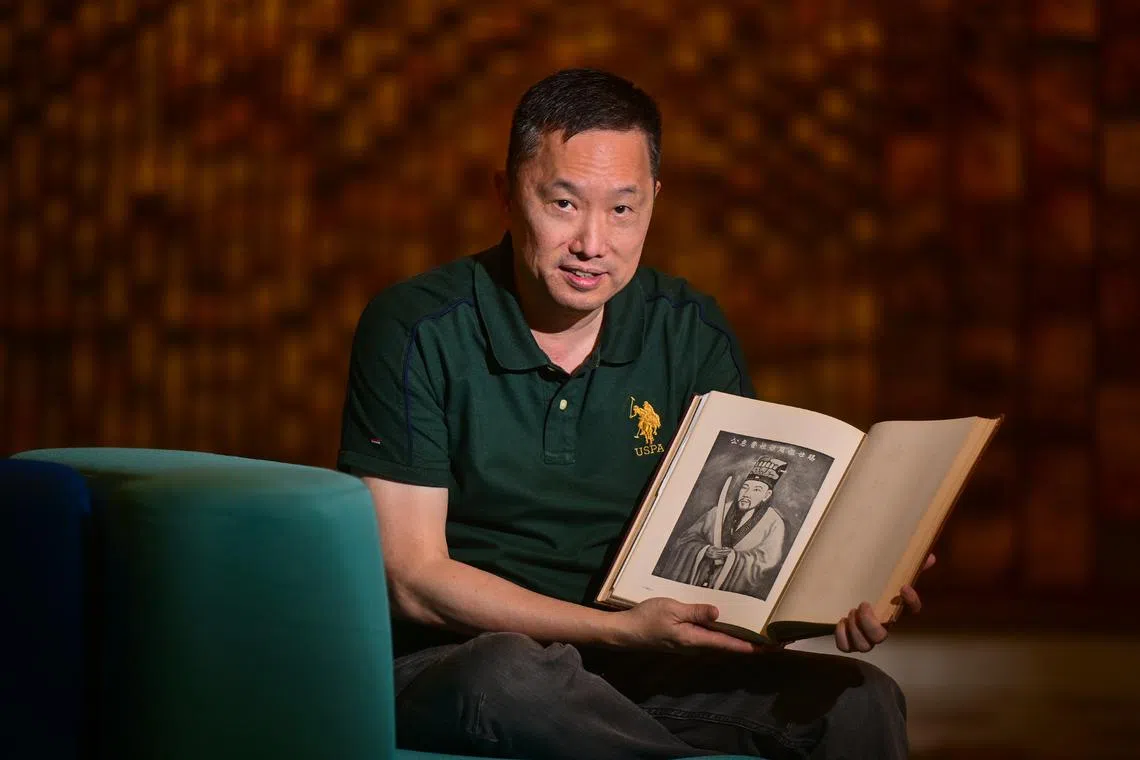 Mr Nathan Co, founder of Chinese Ancestry Research, showing a page from an ancestry book which shows one of his ancestors, Duke Hui of Lu State. 