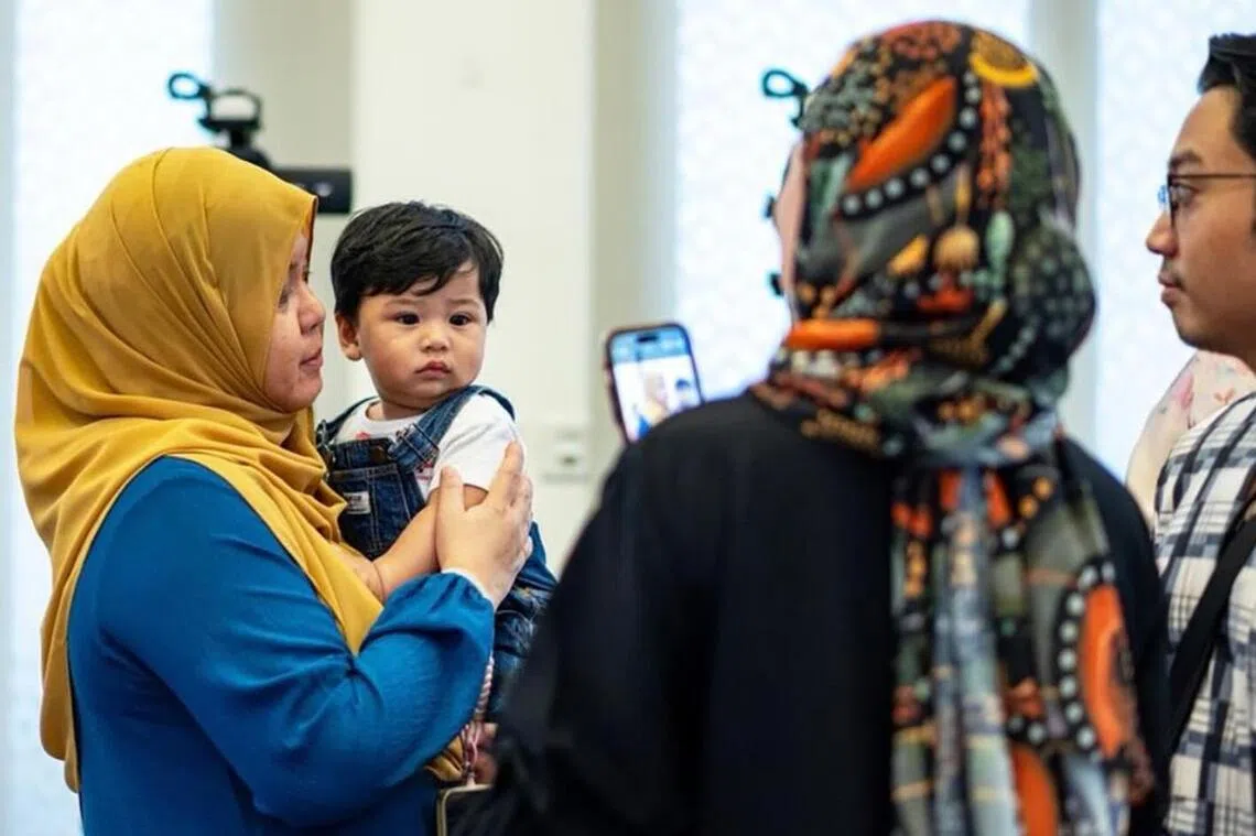 Suzanna Sulaiman (left), deputy chairman of the division of obstetrics and gynaecology at KKH, with a young Malay couple and their baby. The couple were part of Project ARIF.