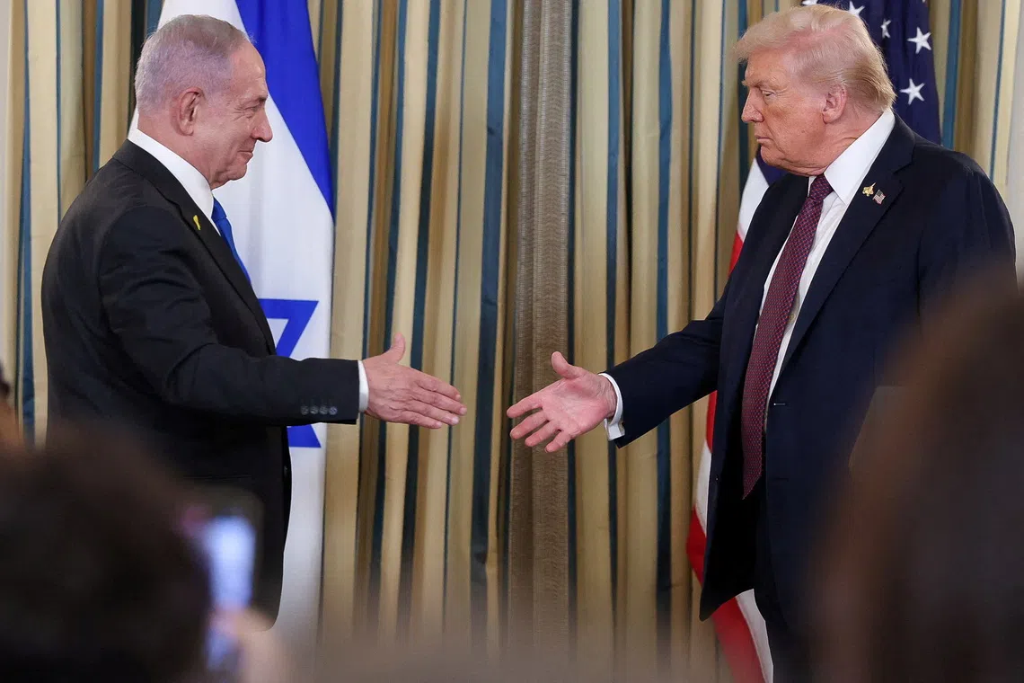 FILE PHOTO: U.S. President Donald Trump and Israeli Prime Minister Benjamin Netanyahu reach to shake hands at a joint press conference in the State Dining Room at the White House in Washington, D.C., U.S., September 29, 2025. REUTERS/Jonathan Ernst/ File Photo