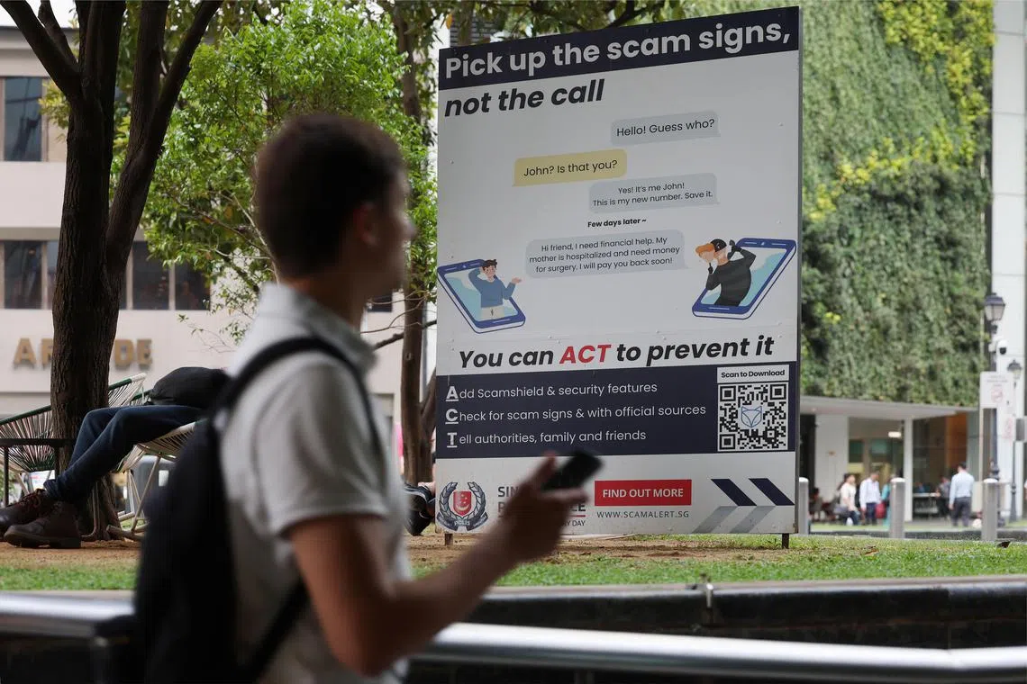 ST20240903_202446800912/pixgenerics/Brian Teo/Passers-by walking past a scam poster outside Raffles Place MRT station on September 3, 2024. Can be used for stories on phone scams, scam, money, phishing, investment scam, romance scam, job scam. ST PHOTO: BRIAN TEO.
