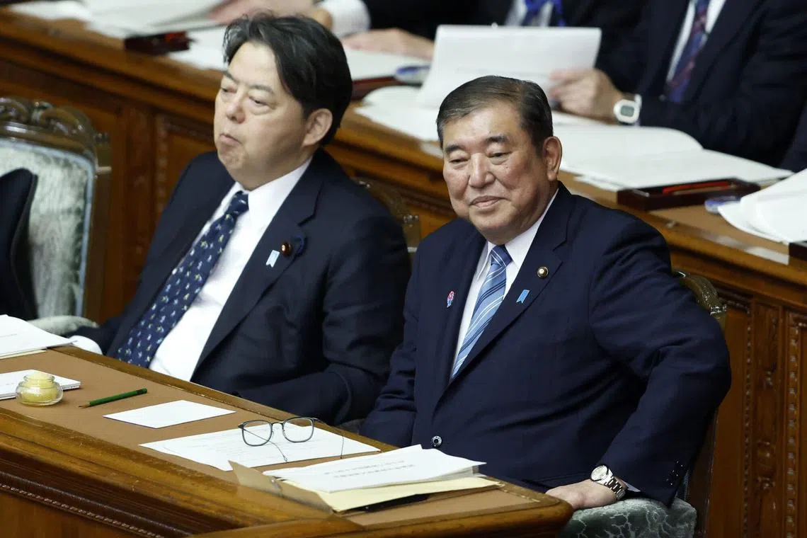Japan Prime Minister Shigeru Ishiba (right) in the Lower House of the Diet on Jan 24, 2025.