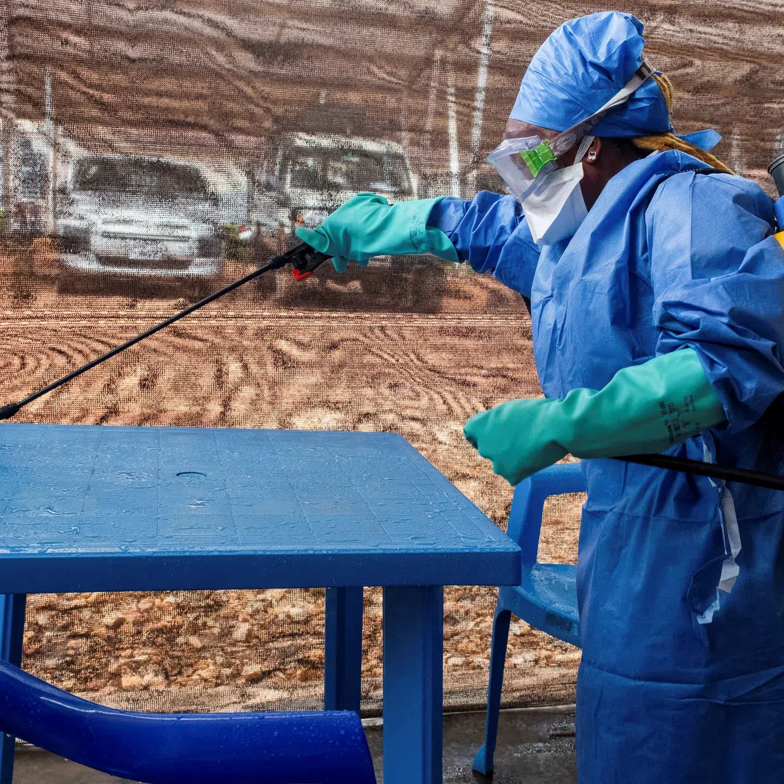A worker wearing personal protective equipment (PPE) disinfects a desk at the Kitatumba Ebola treatment center run by Medecins Sans Frontieres (MSF), as aid agencies intensify efforts to contain a new Ebola outbreak involving the Bundibugyo species, in Butembo, North Kivu province, Democratic Republic of Congo, September 23, 2026. REUTERS/Gradel Muyisa Mumbere