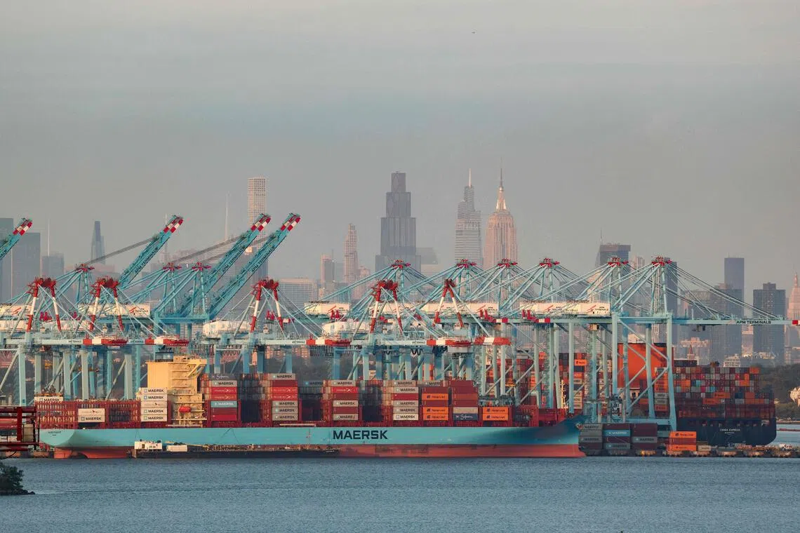 Cargo ships and shipping containers are seen at the Port Jersey Container Terminal in Jersey City, New Jersey on Sept 22, 2025.