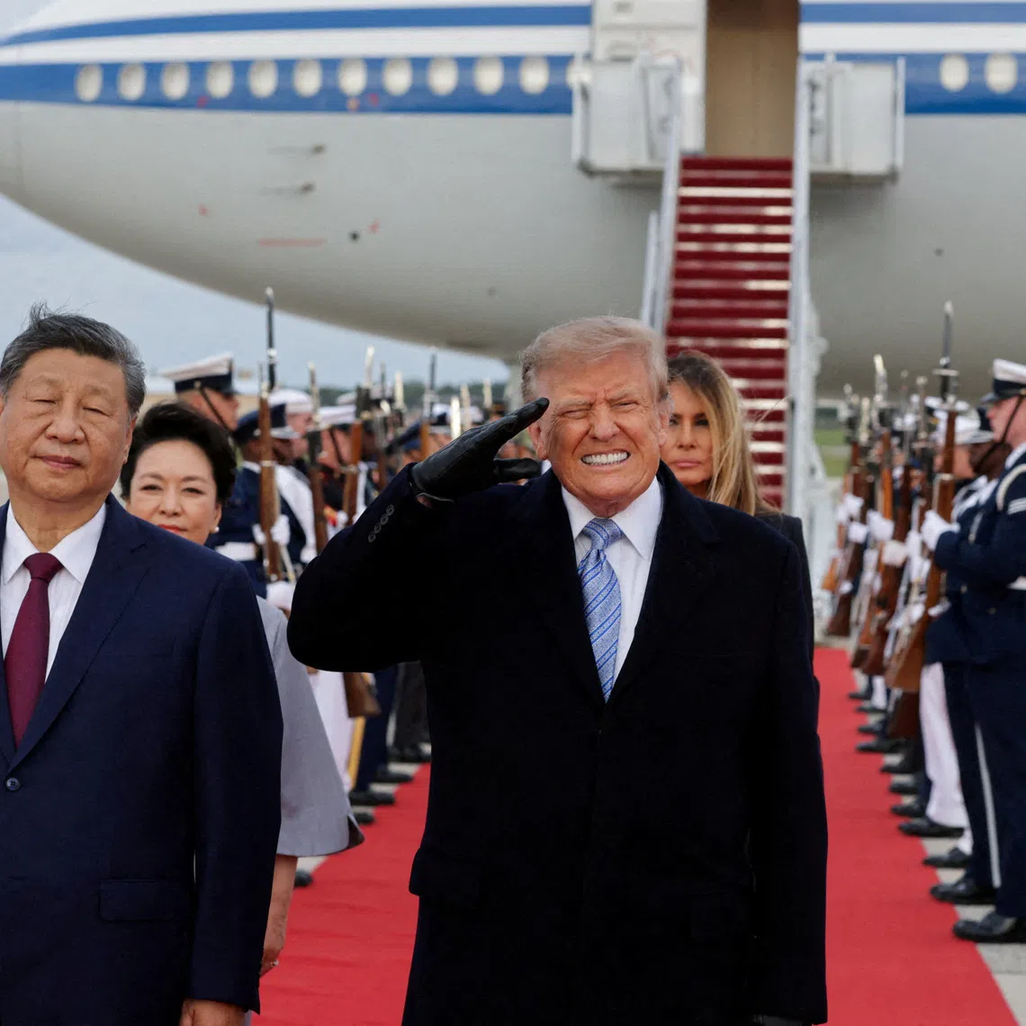 US President Donald Trump reacts to the roar of B-1 bomber flyover during the U.S. national anthem as Trump salutes next to Chinese President Xi Jinping during an arrival ceremony ahead of a state visit at Joint Base Andrews, Maryland, US, September 23, 2026. REUTERS/Jonathan Ernst TPX IMAGES OF THE DAY