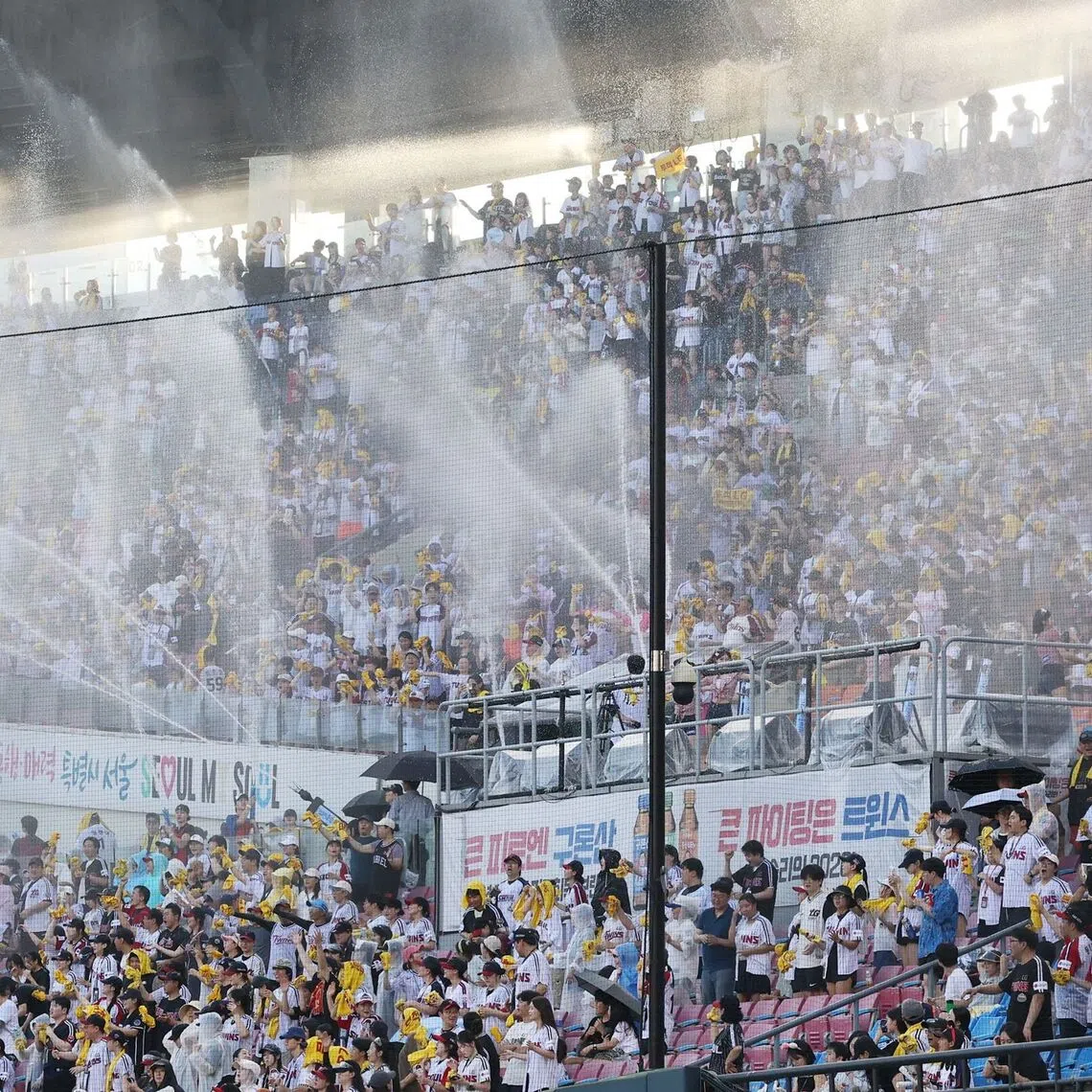 Water cannons are sprayed into the stands to cool off the crowd during a Korean professional baseball game on July 29.