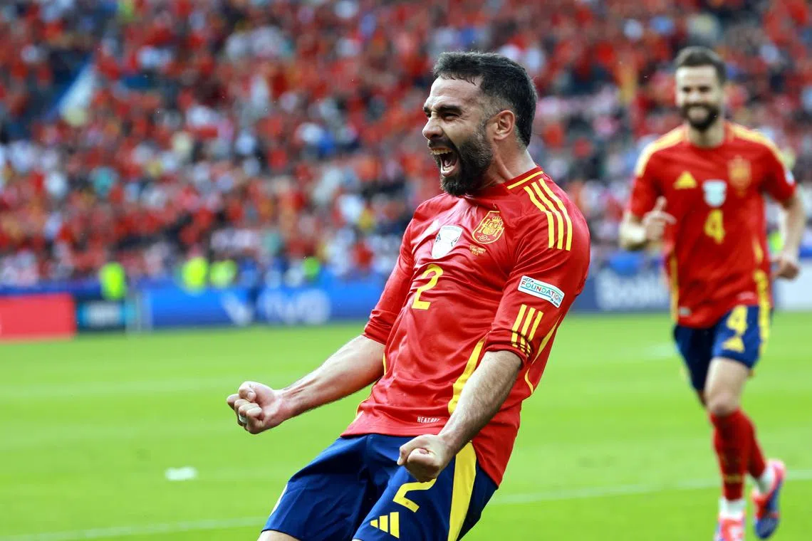 Spain's Dani Carvajal celebrates scoring their third goal.