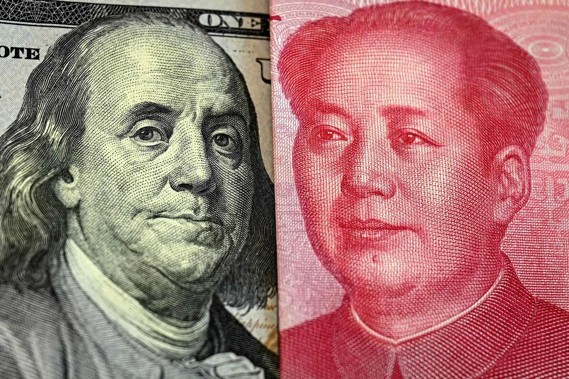 This photo illustration shows a Chinese 100 yuan note (red) and a US 100 dollar note, in Beijing on April 8, 2025. China vowed on April 8 to "fight to the end" against fresh tariffs of 50 percent threatened by US President Donald Trump, further aggravating a trade war that has already wiped trillions off global markets. (Photo by Jade GAO / AFP)