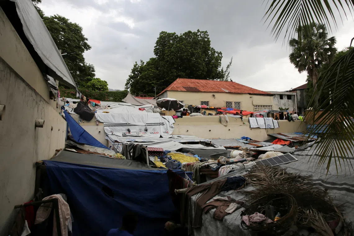General view of people standing at a shelter at the Church of Jesus Christ of Latter-Day Saints, which houses individuals displaced by gang violence, in Port-au-Prince, Haiti June 12, 2025. REUTERS/Jean Feguens Regala