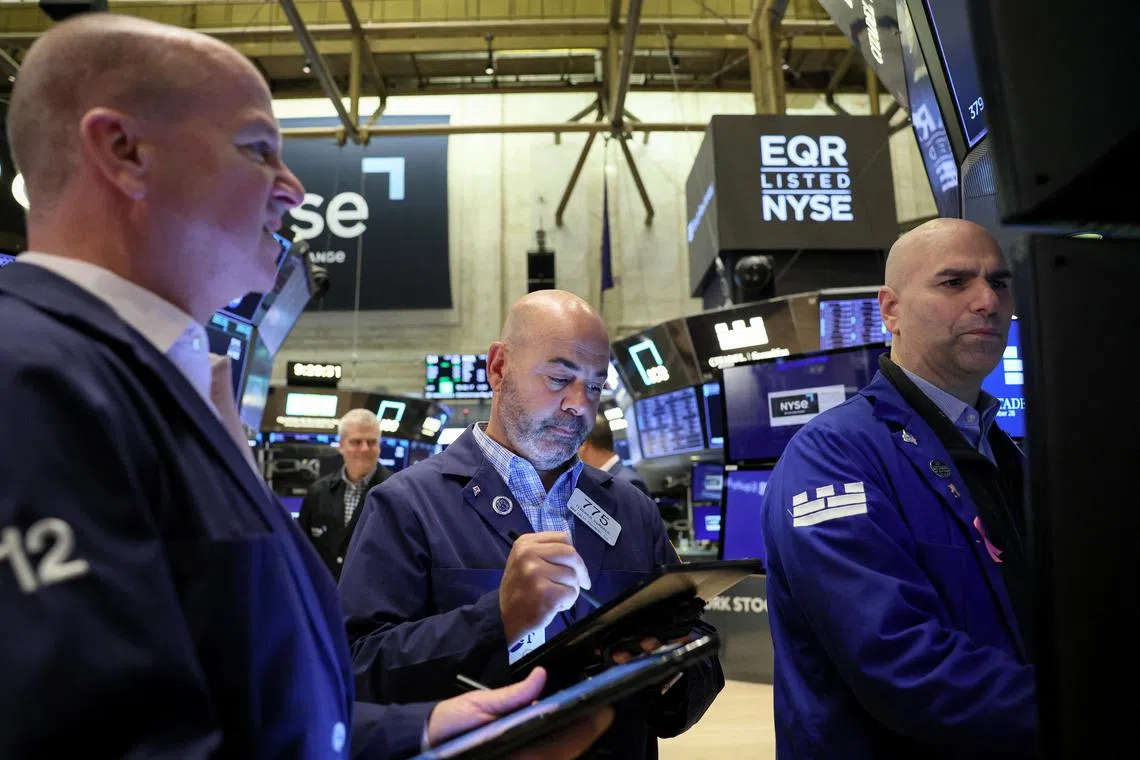 Traders work on the floor of the New York Stock Exchange, in New York City.