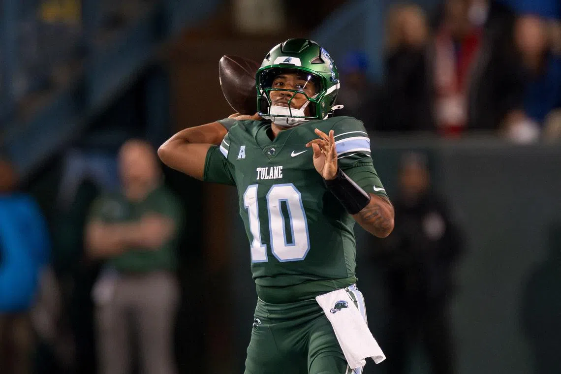 FILE PHOTO: Nov 28, 2024; New Orleans, Louisiana, USA;  Tulane Green Wave quarterback Darian Mensah (10) throws against the Memphis Tigers during the first quarter at Yulman Stadium. Mandatory Credit: Matthew Hinton-Imagn Images/File photo