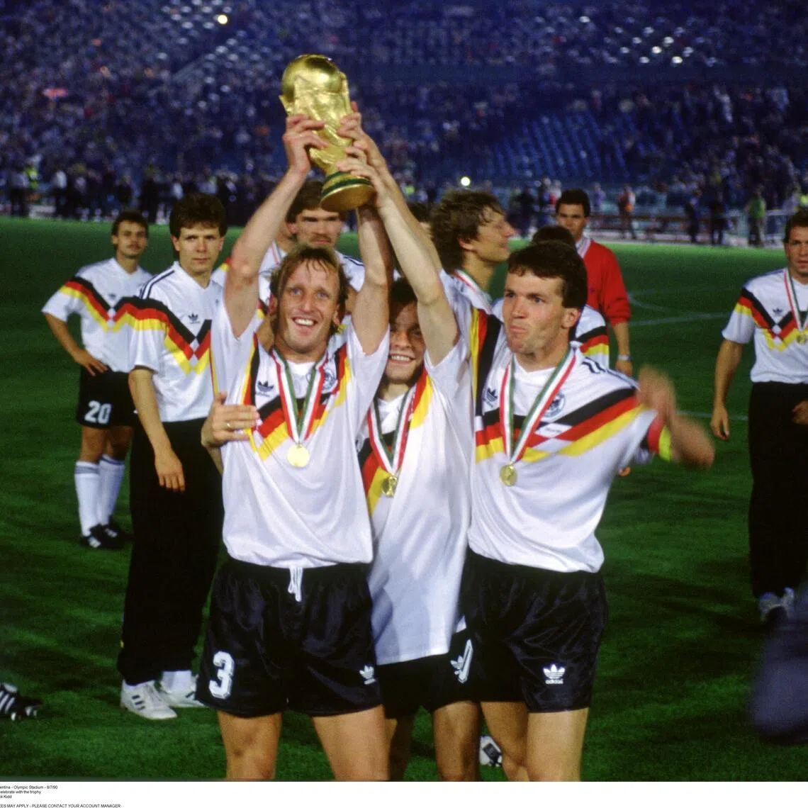 Football - 1990 World Cup - Final - West Germany v Argentina - Olympic Stadium - 8/7/90
West Germany's Andreas Brehme and Lothar Matthaus celebrate with the trophy
Mandatory Credit: Action Images / Sporting Pictures