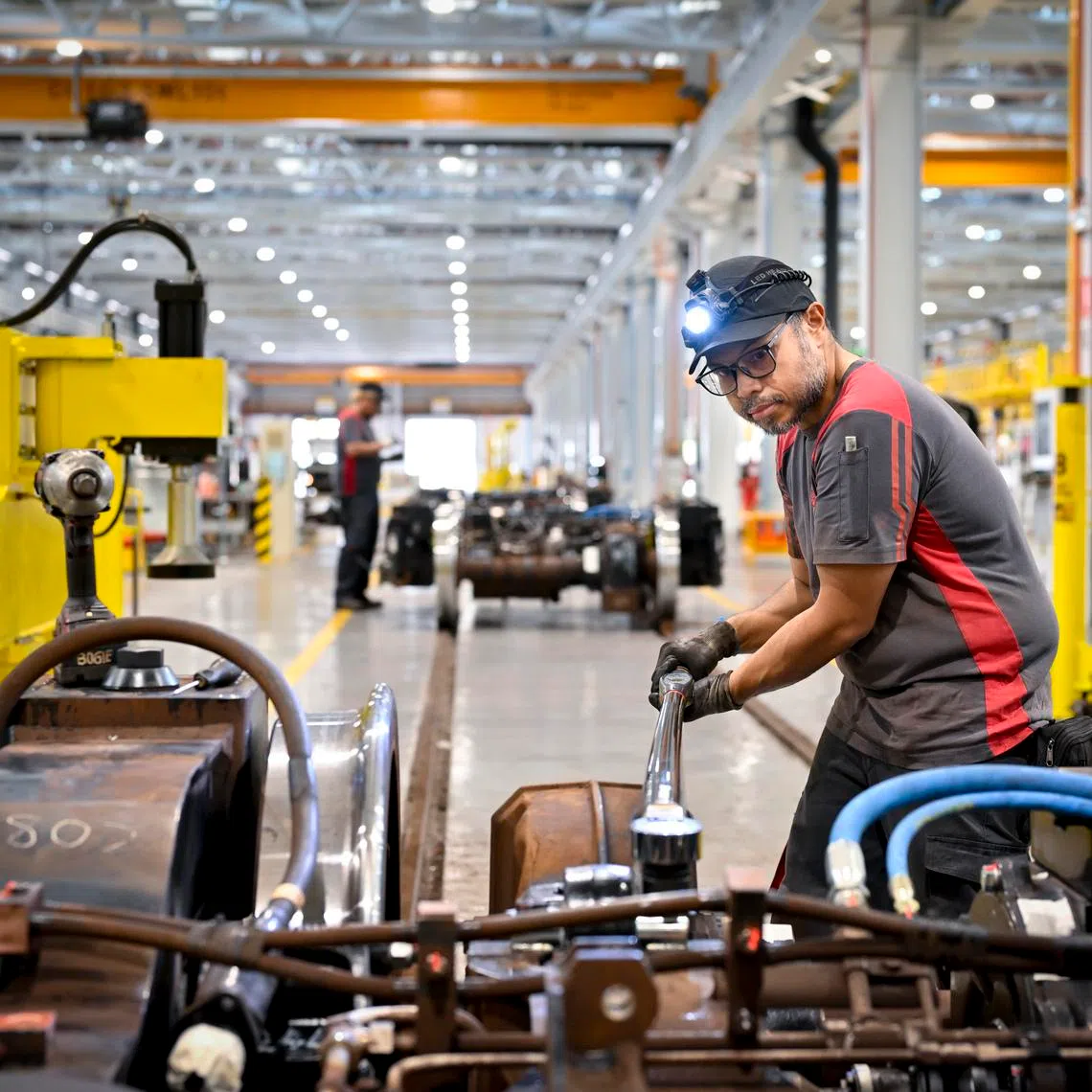Technical officer Muhammad Asyik Abu Bakar using the digital torque wrench, which is equipped with sensors to provide real-time readings and alerts. The tool, part of Depot 4.0, ensures train parts are tightened to exact specifications.