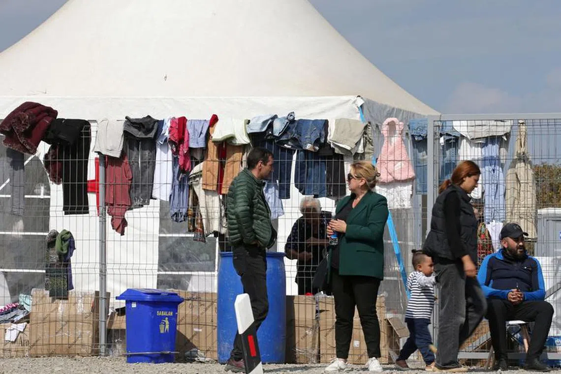 People gather near an aid center for refugees from Nagorno-Karabakh region in the border village of Kornidzor, Armenia, September 29, 2023. REUTERS/Irakli Gedenidze