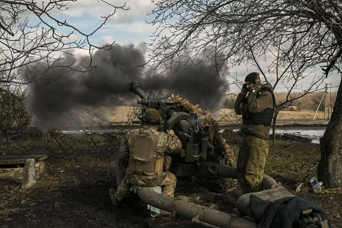 Ukrainian servicemen fire a 105mm Howitzer towards Russian positions, near the city of Bakhmut, on March 4, 2023. (Photo by Aris Messinis / AFP)