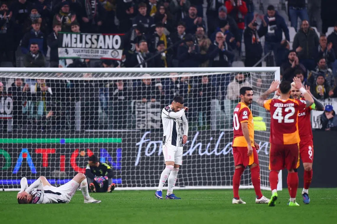 Soccer Football - UEFA Champions League - Play Off - Second Leg - Juventus v Galatasaray - Allianz Stadium, Turin, Italy - February 25, 2026 Juventus' Edon Zhegrova and Filip Kostic look dejected after the match as Galatasaray's Ilkay Gundogan, Abdulkerim Bardakci and Mauro Icardi celebrate REUTERS/Guglielmo Mangiapane