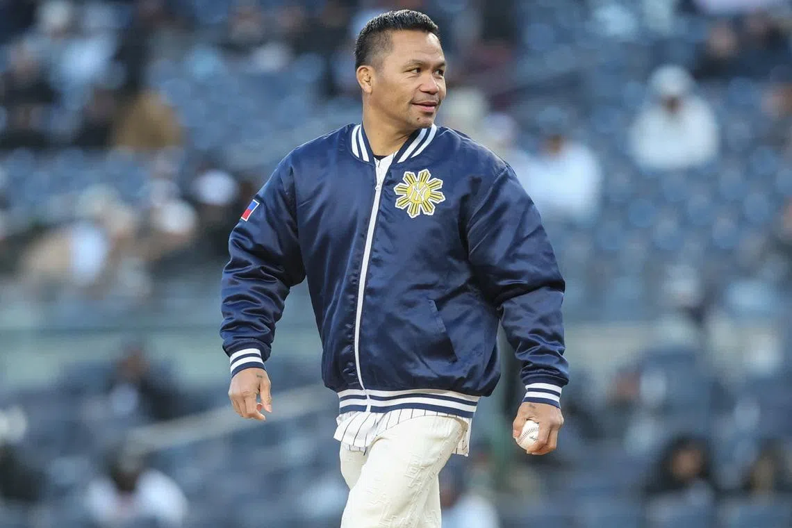Apr 7, 2026; Bronx, New York, USA;  Professional boxer Manny Pacquiao prepares to throw out the first pitch prior to the game between the Athletics and the New York Yankees at Yankee Stadium. Wendell Cruz-Imagn Images