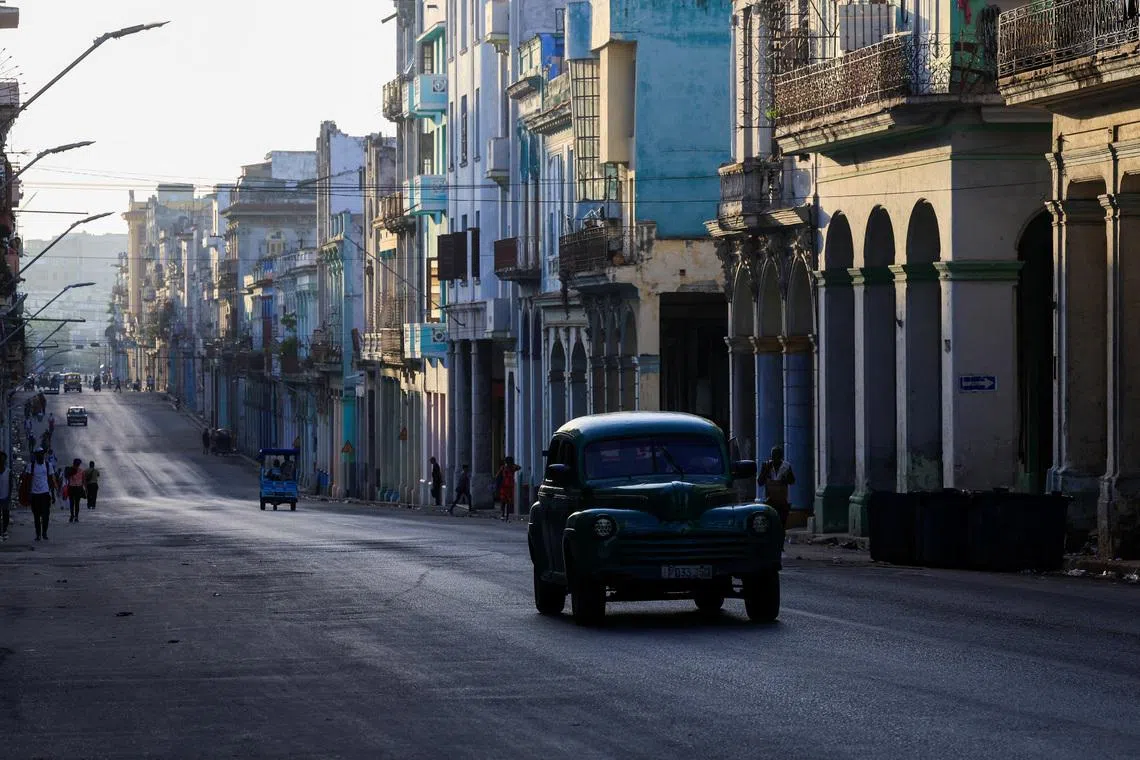 A vintage car drives down a street ahead of an announcement by Cuba's grid operator UNE that it had reconnected most of the country to the national grid, though millions remained without power as the country struggles to generate even one-third of current demand amid an ongoing U.S. fuel blockade, in Havana, Cuba, July 7, 2026. REUTERS/Norlys Perez