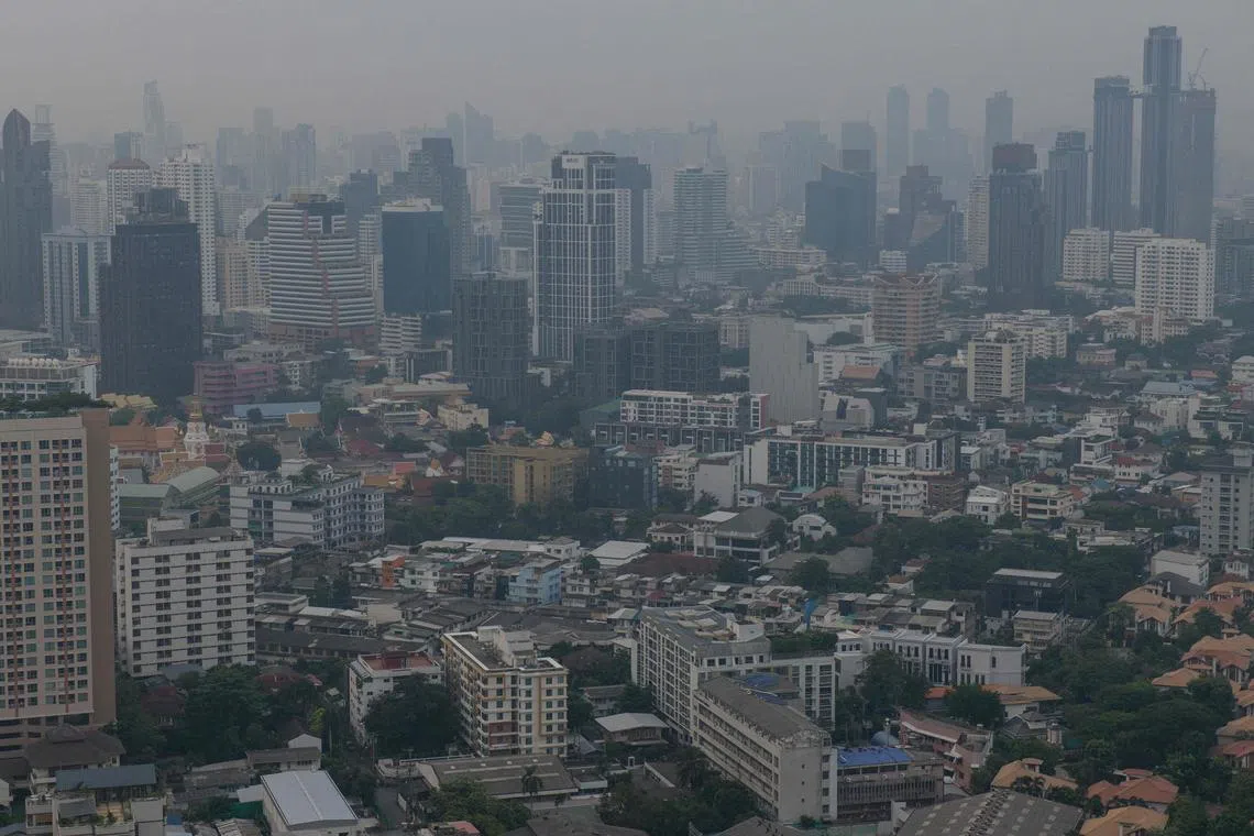 The city skyline is pictured amid high levels of air pollution in Bangkok on October 18, 2023. Thai officials promised action on October 20, 2023 to address a spike in air pollution that came before the normal peak of seasonal haze, but environmental activists accused authorities of hot air. (Photo by Alex OGLE / AFP)