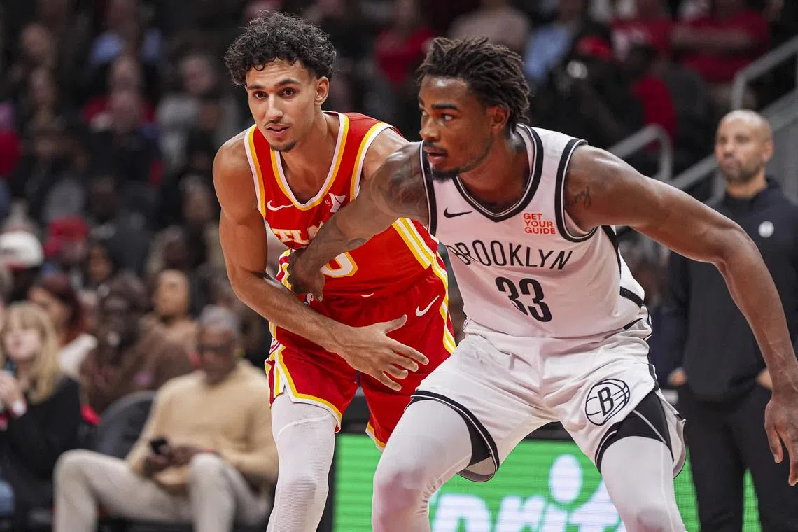 Atlanta Hawks forward Zaccharie Risacher tries to get position on Brooklyn Nets centre Nic Claxton during the second half at State Farm Arena. 