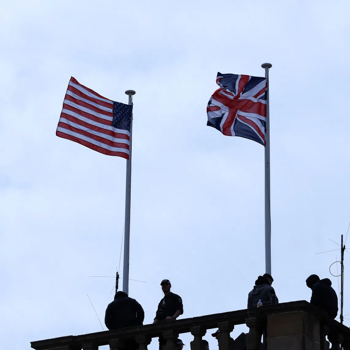 Security personnel stand guard, as a Union Jack and U.S. flag flutter on a roof, on the day of a meeting between U.S. President Donald Trump and British Prime Minister Keir Starmer, at Trump Turnberry golf course in Turnberry, Scotland, Britain, July 28, 2025. REUTERS/Evelyn Hockstein
