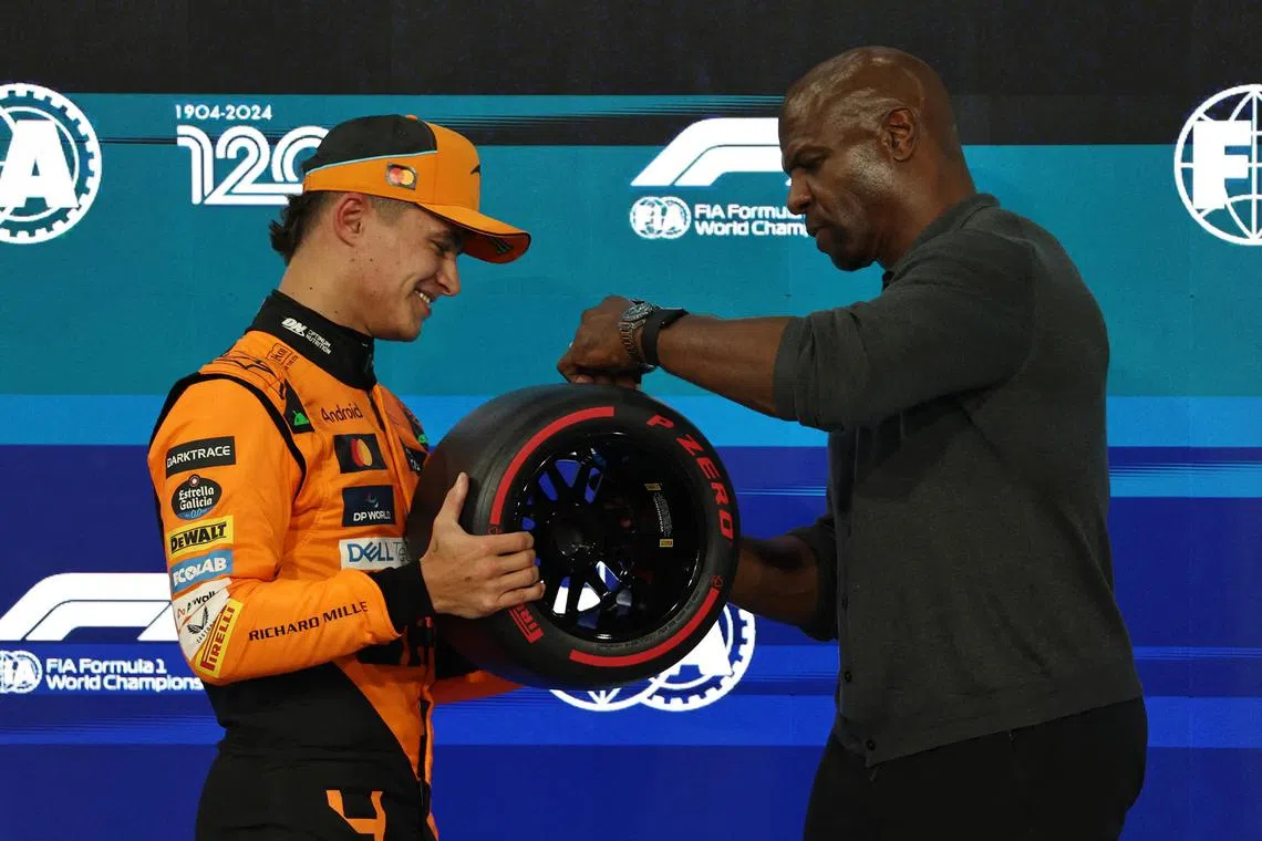 McLaren's Lando Norris with Hollywood actor Terry Crews after qualifying in pole position at the Abu Dhabi Grand Prix.