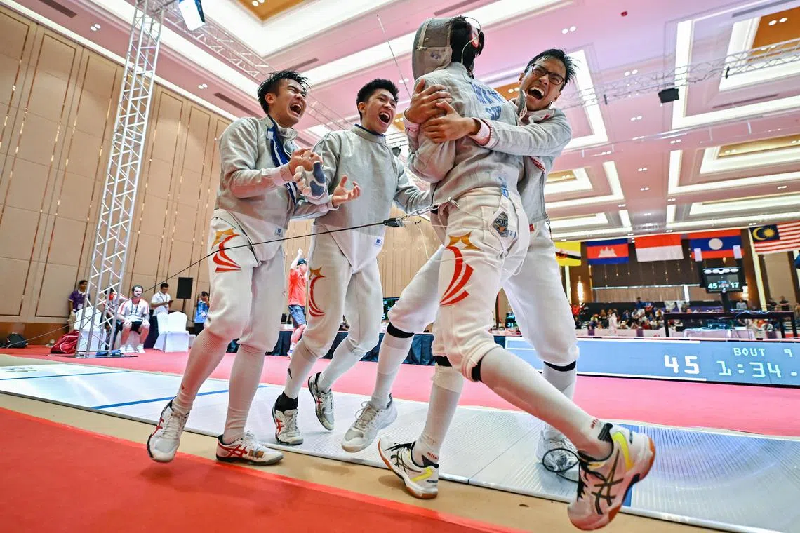 Fencers Dan Wei Zuo, Nicholas Loo and Jorelle See celebrating with Lucius Loh after reaching the men's sabre team final for the first time with the 45-41 semi-final win over Thailand. 