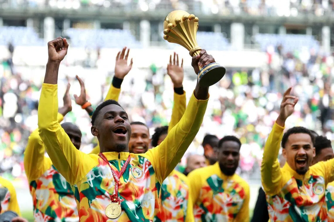 Senegal's Moussa Niakhate celebrates with Africa Cup of Nations trophy. The team have been stripped of their title and are awaiting the result of an appeal.
