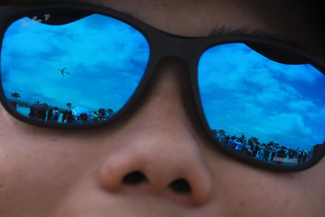 A Comac C919 is seen in the reflection of a spectator’s sunglasses during the aerial display at the Singapore Airshow on Feb 21, 2024.
