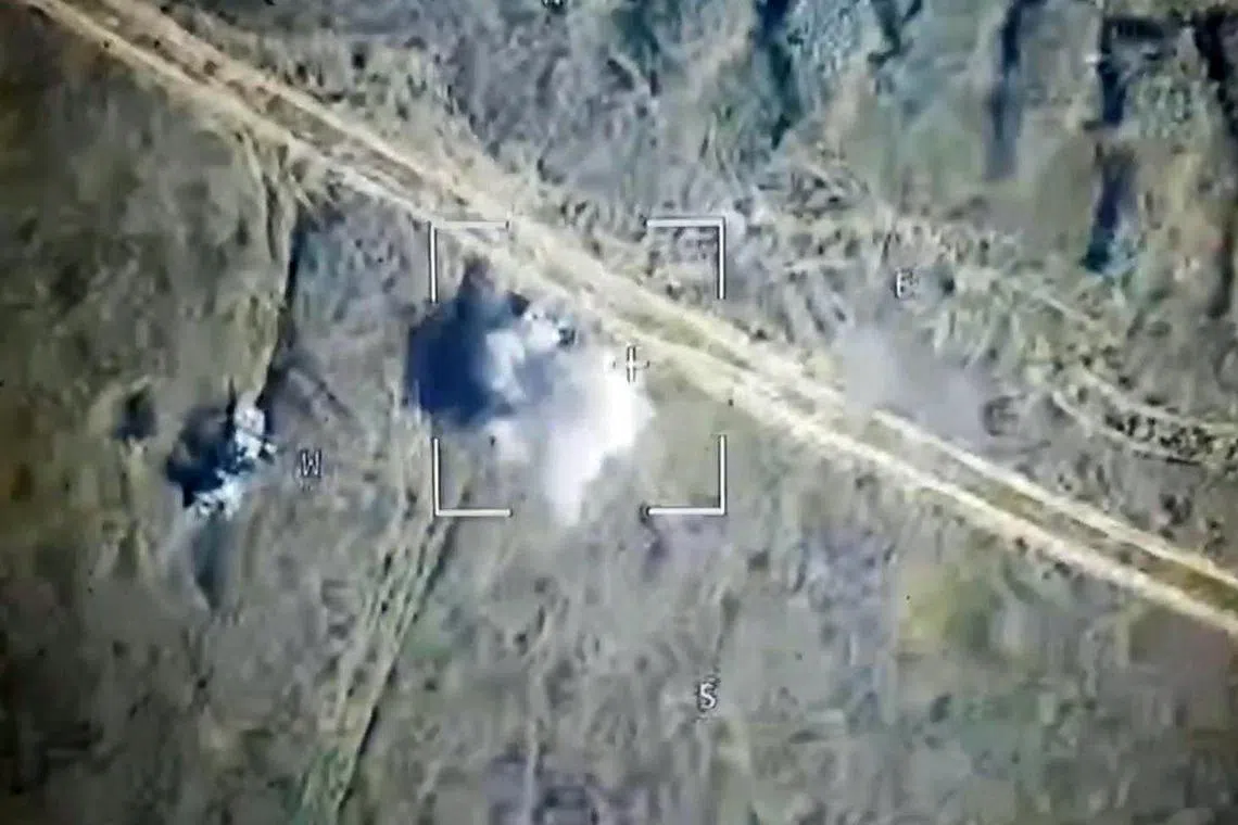 Handout footage from Russia reportedly shows a Russian drone attack on Ukrainian armoured vehicles outside the town of Sudzha, in Russia's Kursk region.