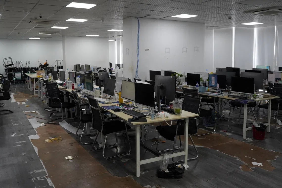 Computers and workstations seized by police during an online scam crackdown at a hotel in Phnom Penh, Cambodia, March 11, 2026. REUTERS/Roun Ry