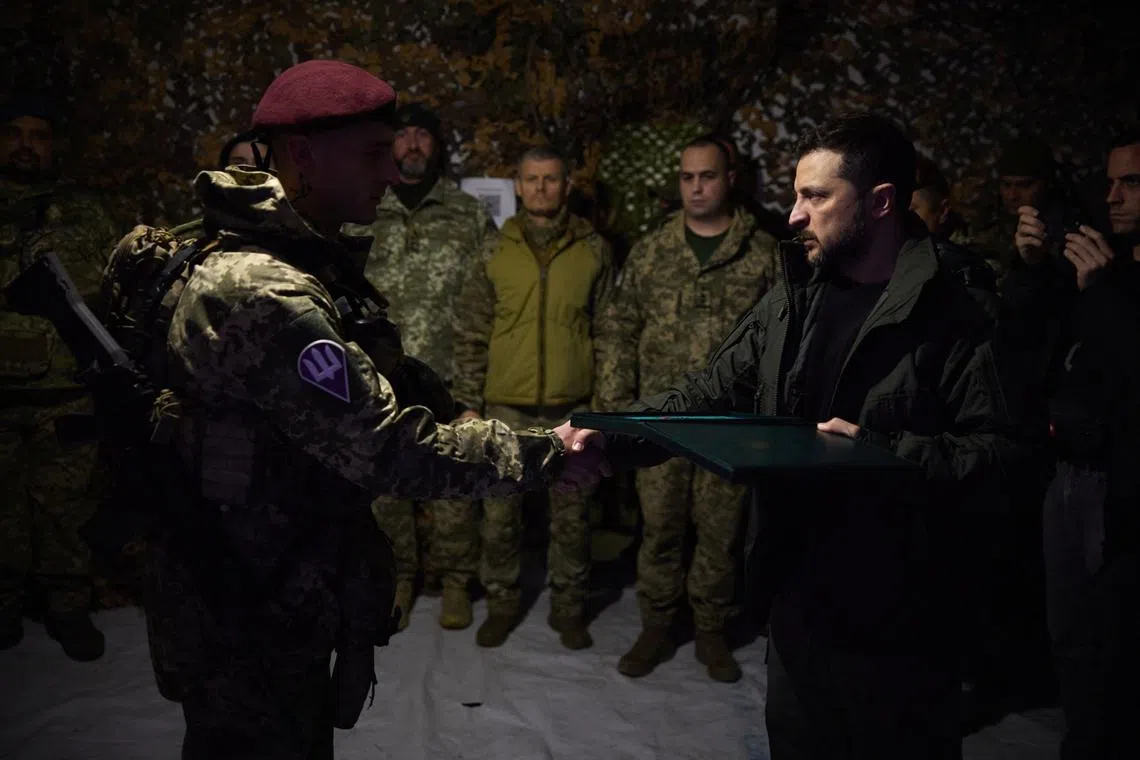 Ukraine's President Volodymyr Zelenskiy awards a Ukrainian service member during his visit on a frontline, amid Russia's attack on Ukraine, in the town of Pokrovsk in Donetsk region, Ukraine November 18, 2024. Ukrainian Presidential Press Service/Handout via REUTERS