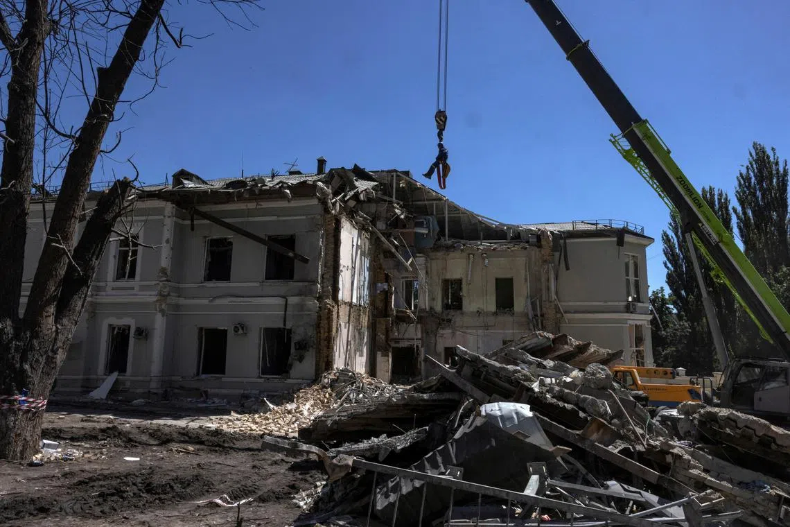 FILE PHOTO: A emergency service worker is suspended above the blast site following a Russian missile strike on the Okhmatdyt Children's Hospital, amid Russia's attack on Ukraine, in Kyiv, Ukraine July 9, 2024. REUTERS/Thomas Peter/File Photo