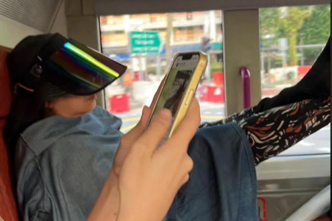 The woman was seen resting her feet on the seat in front of her, as well as against a pole in the bus. 