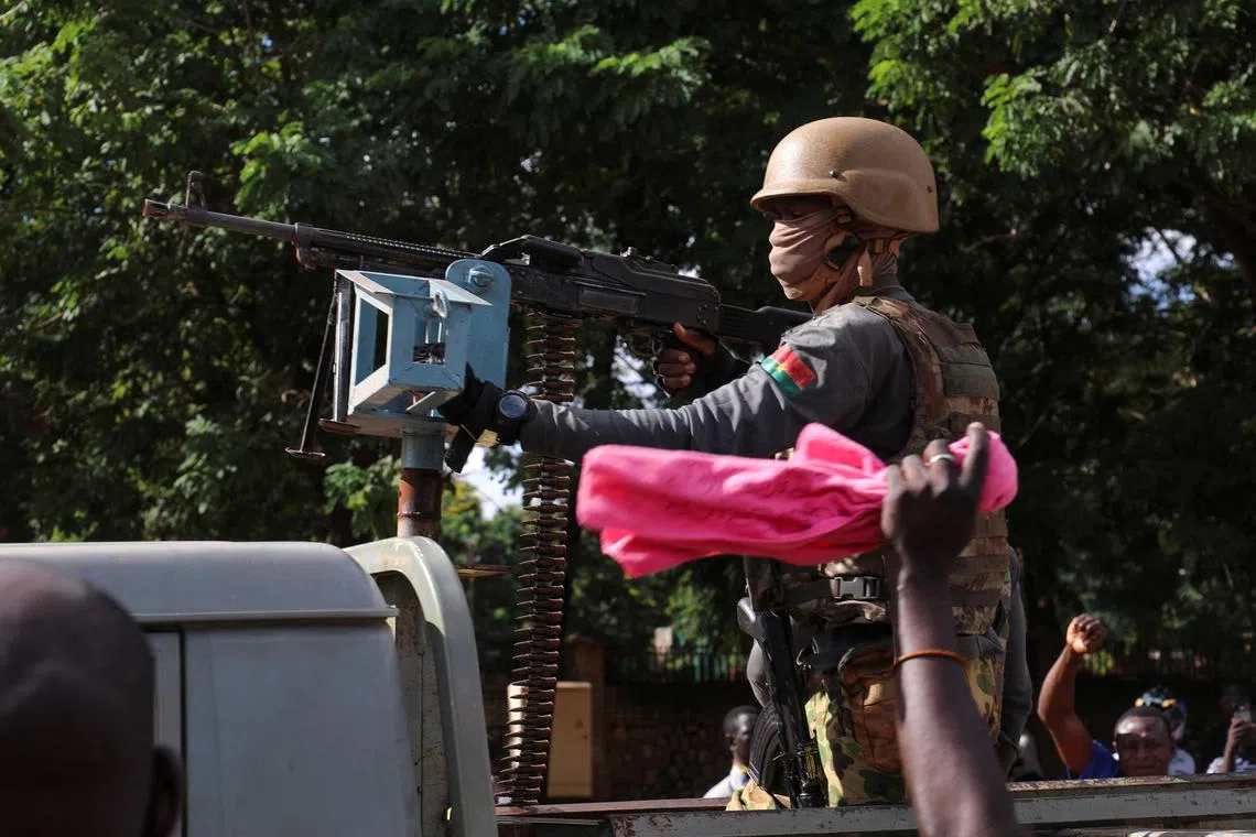 FILE PHOTO: New junta's soldiers stand guard in an armoured vehicle in Ouagadougou, Burkina Faso October 2, 2022. REUTERS/Vincent Bado/File Photo