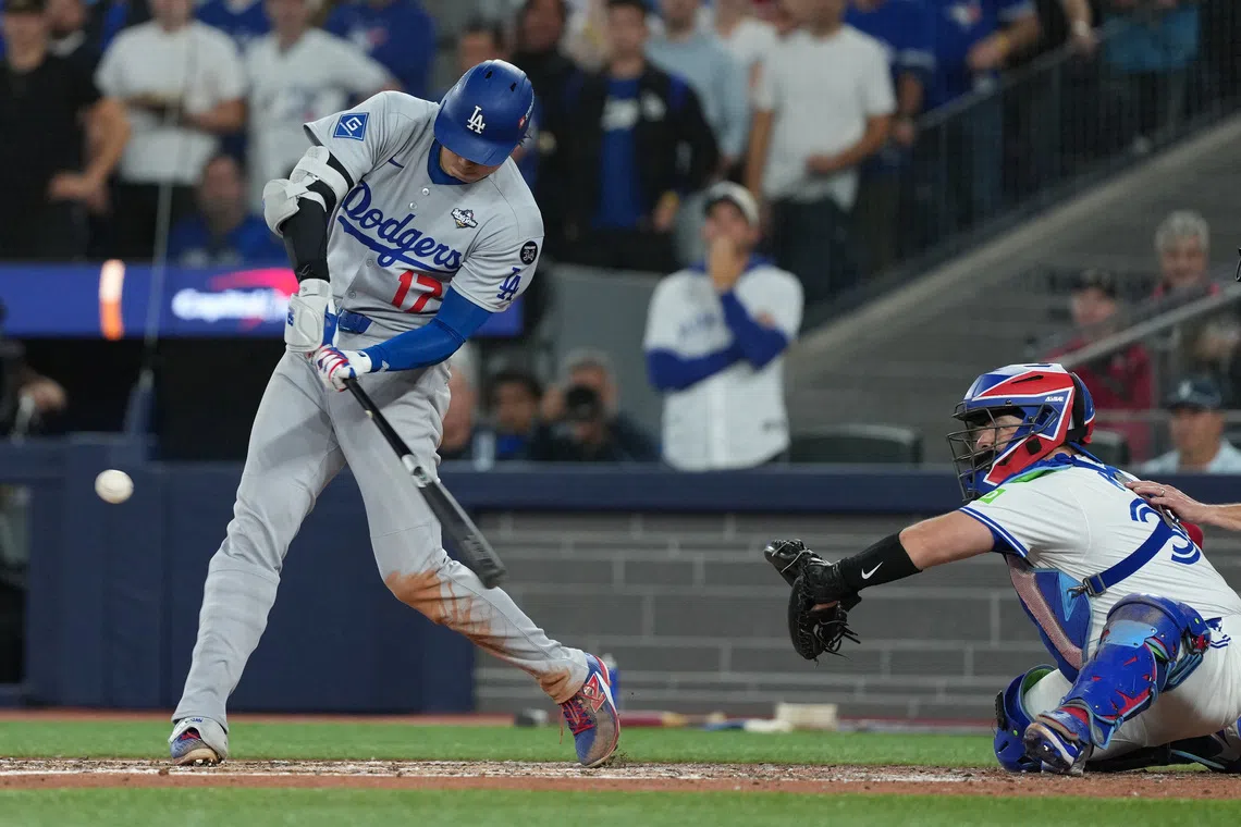 Nov 1, 2025; Toronto, Ontario, CAN; Los Angeles Dodgers two-way player Shohei Ohtani (17) hits a single in the fifth inning for game seven of the 2025 MLB World Series at Rogers Centre. Mandatory Credit: Nick Turchiaro-Imagn Images