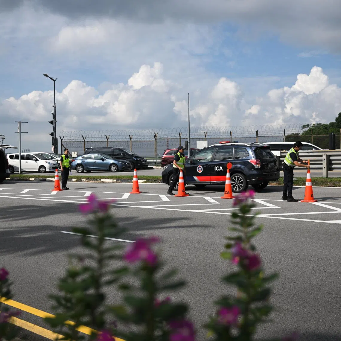 ICA personnel installing cones along a lane at Woodlands Checkpoint on May 30.