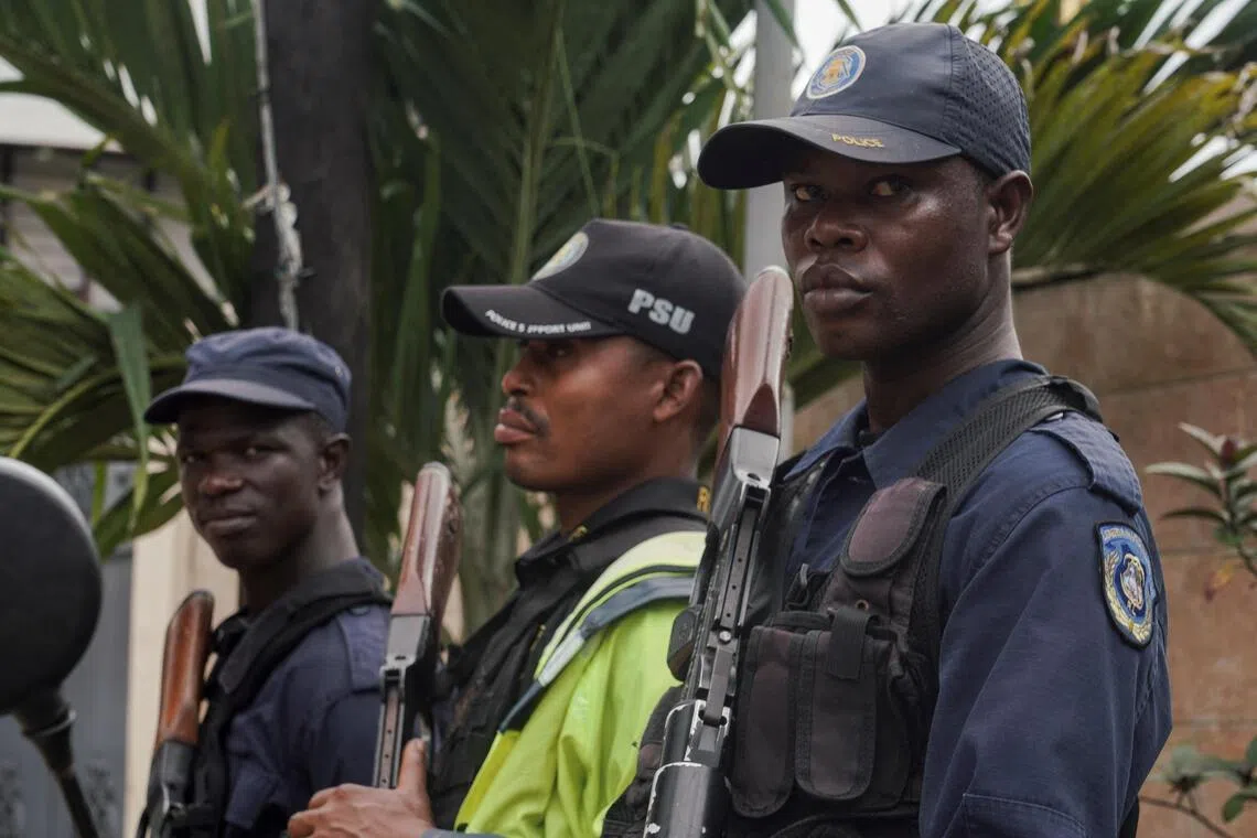 Security guards standing outside a building near Roberts International Airport in Harbel, near Monrovia, on Aug 20, as the arrival of deportees from the US is expected.