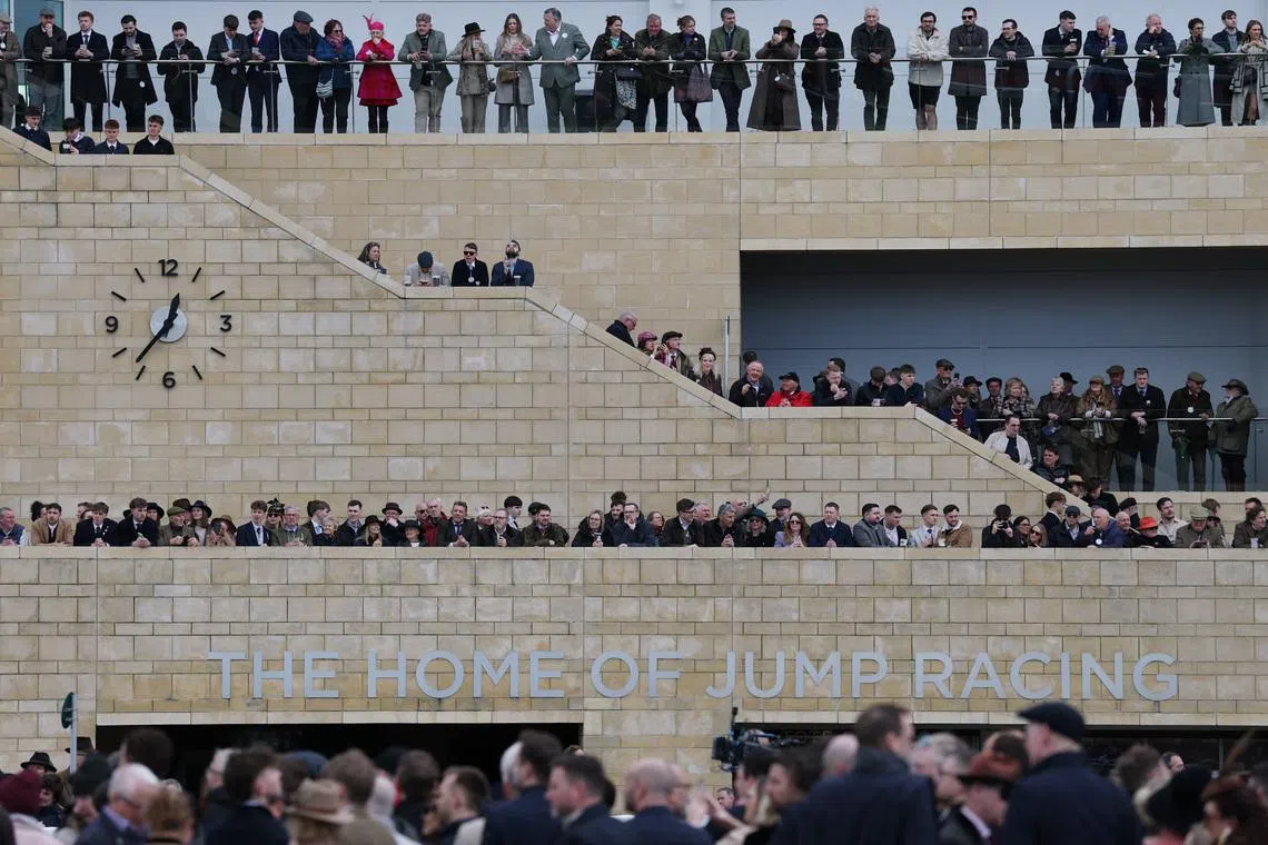 Racegoers are seen ahead of the day's horse races at Cheltenham Racecourse in Britain, March 10.