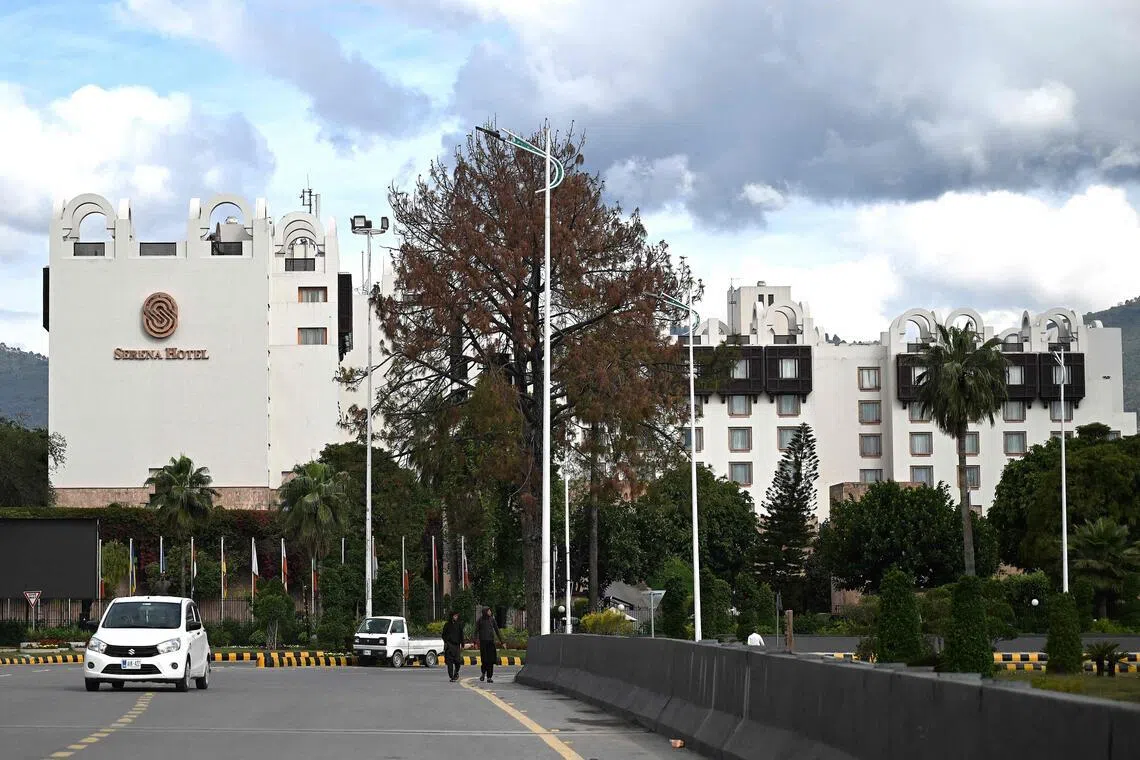 Commuters drive past the Serena Hotel, the expected venue for US–Iran talks in Islamabad, on April 9, 2026.