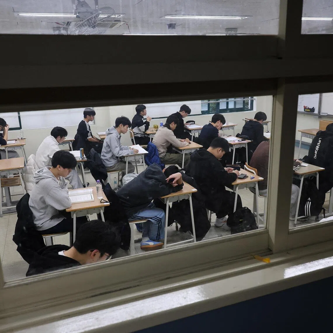 Students wait for the start of the annual college entrance examinations at an exam hall in Seoul, South Korea on Nov 13, 2025.  