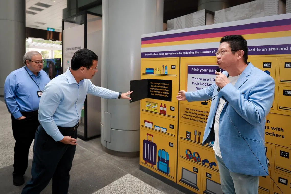 Minister for National Development and Minister-in-charge of Social Services Integration Desmond Lee listening to a presentation by Pick Network CEO New Soon Tee (right) in front of a mockup of the company’s Pick Locker at the URA exhibition "Delivering into the future: Enabling safe and efficient deliveries" at the URA Centre on Nov 15, 2024. With them is URA chairman Peter Ho (left, blue top)