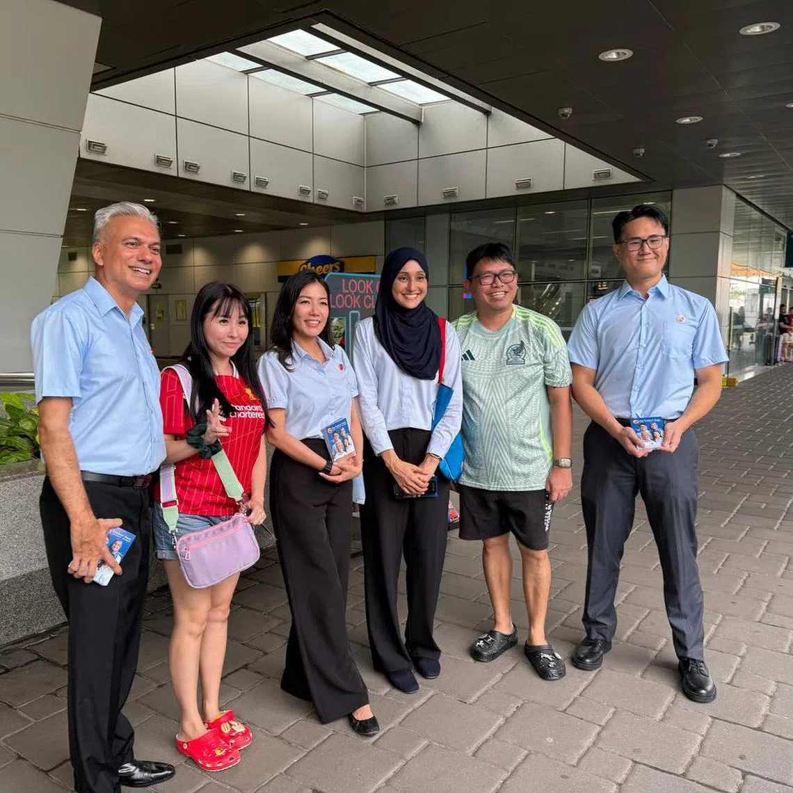 WP's Punggol GRC team, consisting of Mr Harpreet Singh (left), Ms Alexis Dang (thrid left), Ms Alia Mattar (third right) and Mr Jackson Au (right) with residents outside Punggol MRT station on April 23.