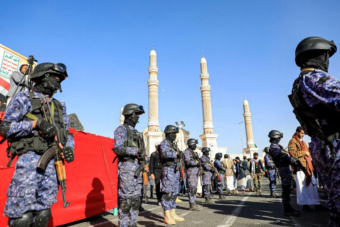 Yemen's Houthi-affiliated security forces stand guard during a march in solidarity with the people of Gaza, in the capital Sanaa. 