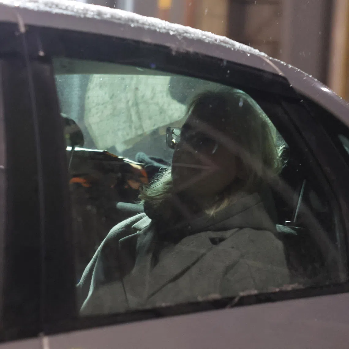 Diana Loginova, a teenage street musician performing under the name Naoko and singing in the Stoptime group who served three short jail stints for singing anti-Kremlin songs, sits in a car as she is escorted out of a temporary detention facility after her latest 13-day jail period ended in Saint Petersburg, Russia November 23, 2025. REUTERS/Anton Vaganov